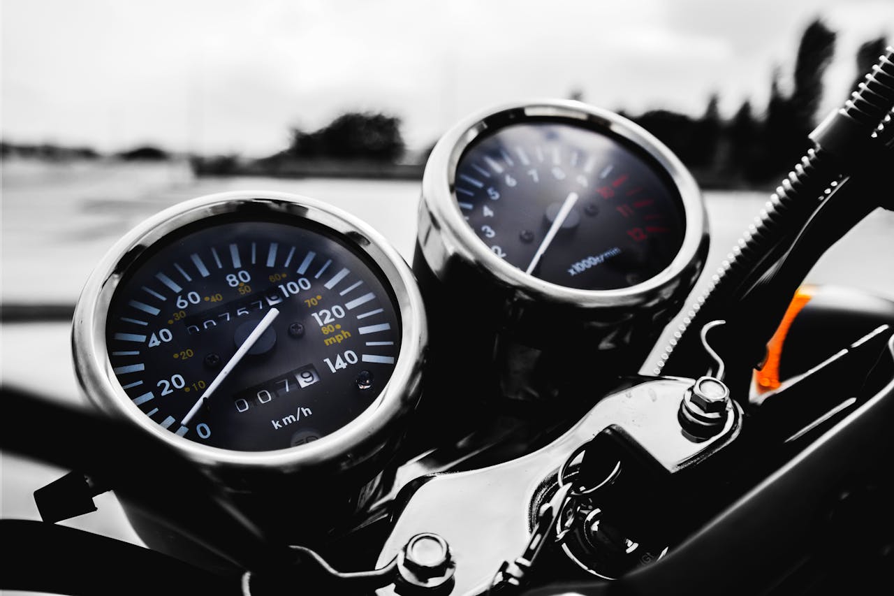Close-up of motorbike speedometer and tachometer, symbolizing precision and reliable motorcycle transport services
